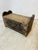This antique piece is a footstool with a lift-top storage compartment. Description: • Form: Rectangular wooden box with a...