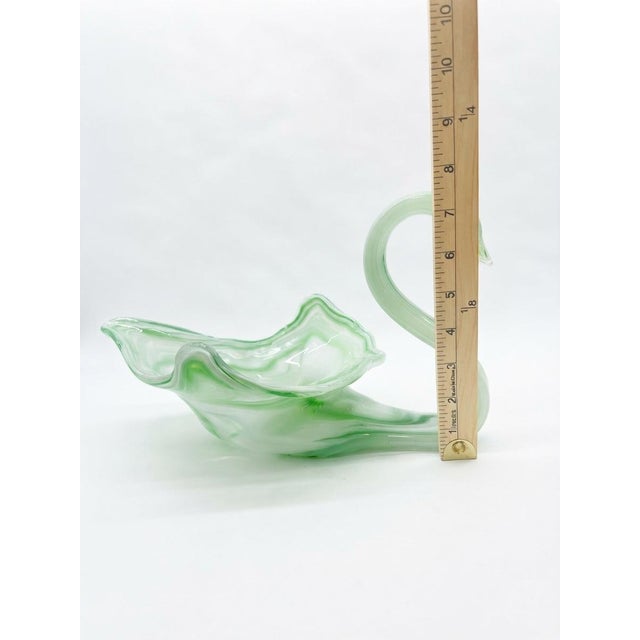 Charming mid-century hand-blown art glass swan figurine featuring a graceful, arched neck and a flowing, ruffled body with...