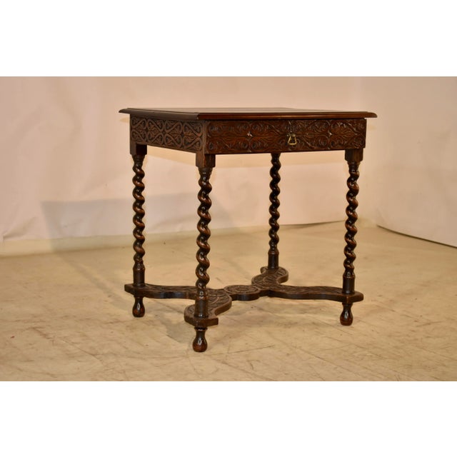 Louis XV period 18th century walnut side table from France. The top is made from two planks, with a beveled edge and...