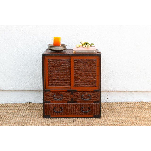 This charming antique Japanese tansu chest, crafted with a faux bamboo texture embodies the elegance and ingenuity of...