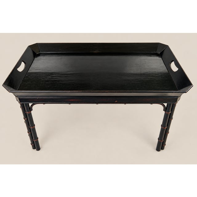 Vintage faux bamboo tray table made by Baker Furniture. Original paint with faint dark maroon accents throughout piece....