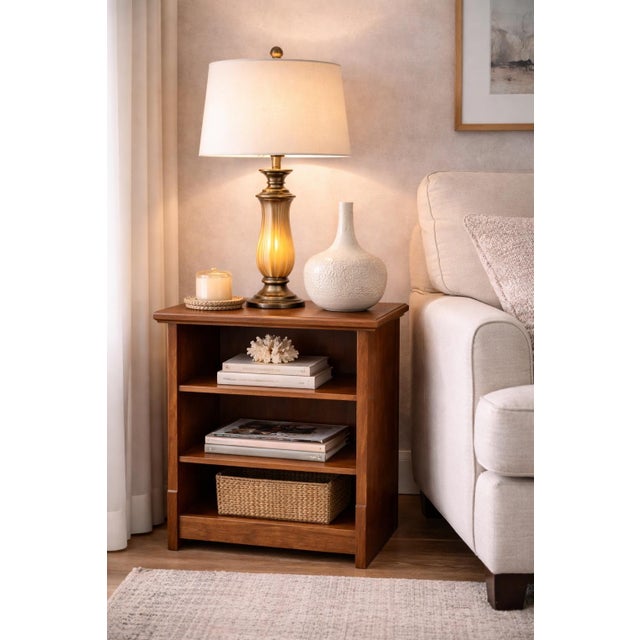 A versatile solid wood open-shelf end table in a rich cognac walnut finish, offering adjustable storage and clean,...