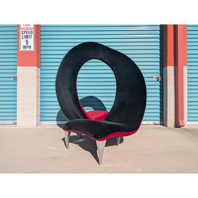 Iconic and theatrical vintage tête-à-tête Flamenco chair, dating to the 1990s, featuring a dramatic sculptural form...