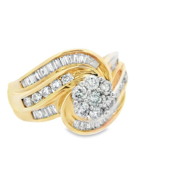 This gorgeous diamond swirl ring is made in 14k yellow gold with both round and baguette cut diamonds. The center of the...