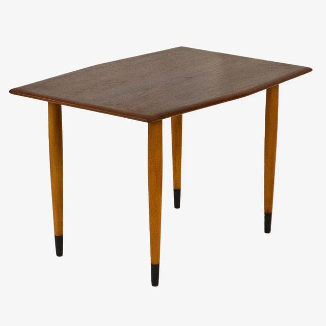 Everything about this pair of Modern Teak and Brass side tables by Dux of Sweden is subtle, delicate, and stylish. The...
