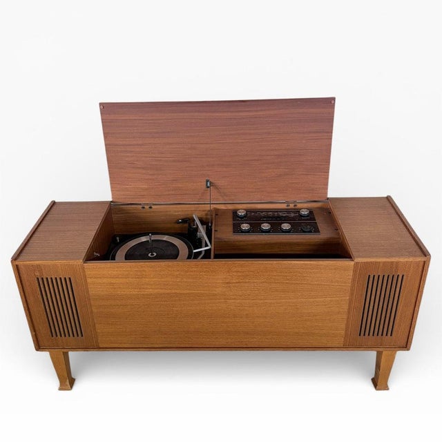 A classic mid-century Stereosound teak radiogram, combining warm Scandinavian-influenced cabinetry with integrated...