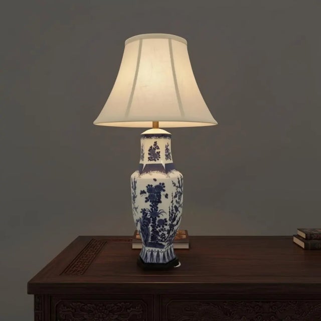 Discover the timeless elegance of this Antique Blue and White Chinese Porcelain Lamp, an exquisite antique porcelain vase...