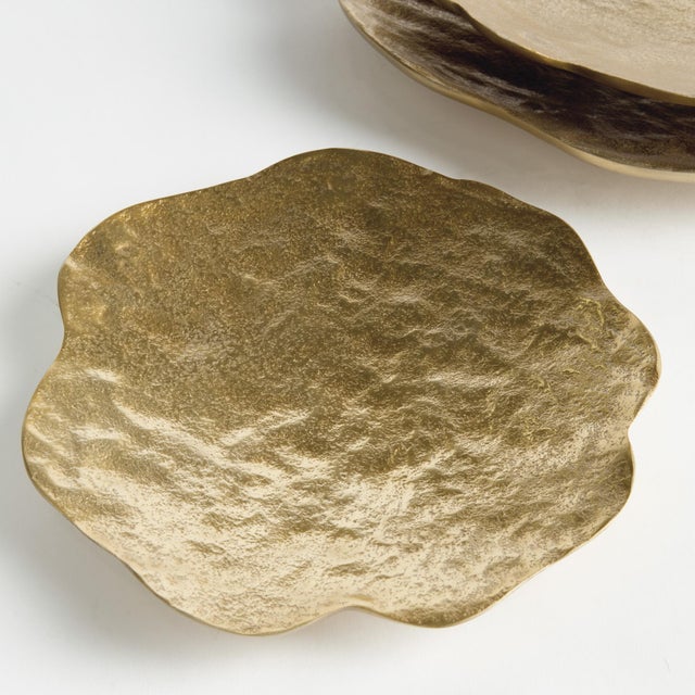 This set of 3 handcrafted bowls has simple, floralinspired silhouettes, with a matte finish and hammered texture. They can...