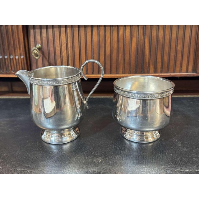 English silver-plated metal tea/coffee service from the 1930s by Mappin&Webb, consisting of a teapot, a sugar bowl and a...