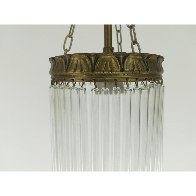 Solid brass hanging lamp with glass rods. The lamp gives a cozy non -dazzling light. The light is spread through the glass...