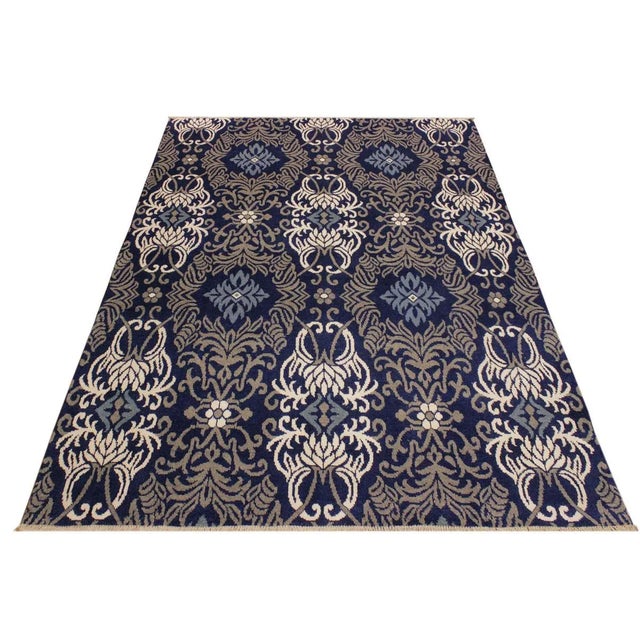 This elegant hand knotted rug features a modern fusion of beauty, with its interlocking geometric and minimalist pattern....