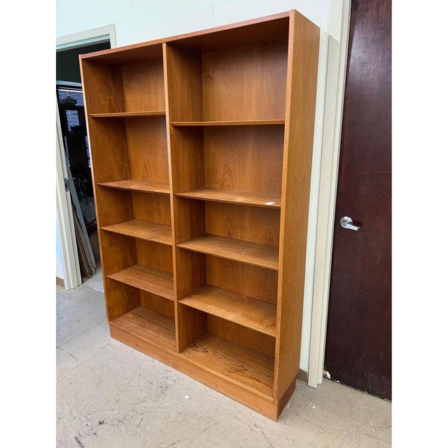 1970s Mid century Danish Modern Hundevad Style 2 Row Teak Bookcase Plinth base and 8 adjustable shelves Good condition...