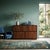 Sideboard with hinged doors and open drawers, in exotic wood veneer with brass handles. Fully restored. This piece is...