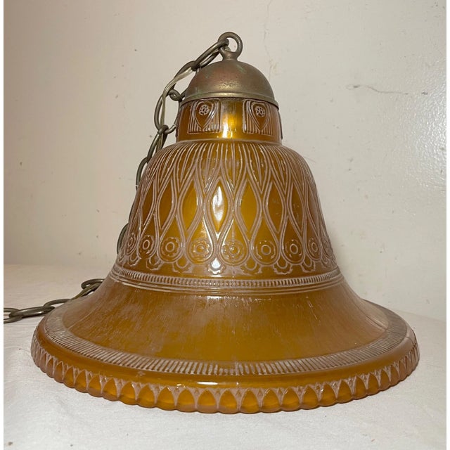 Add a touch of elegance to your home decor with this exquisite large amber glass and brass hanging fixture. The chandelier...