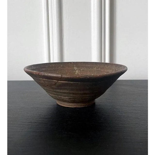 A "Kakinoheta" type ceramic chawan (tea bowl) made in Korean during Joseon dynasty circa 16th-17th century. The bowl has a...