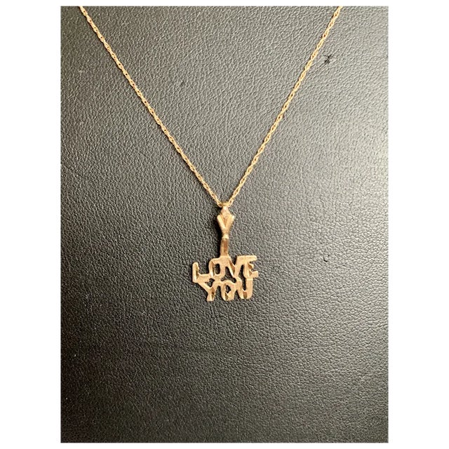 14k Gold I Love You pendant/charm. This pendant has each word stacked and centered on top of the other. The letters are...