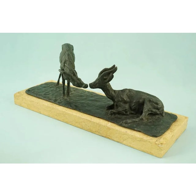 A magnificent bronze sculpture depicting a pair of chamois, set on a royal yellow marble base. The sculpture is signed...