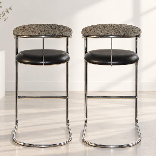 Vintage 1980s tall bar stools. Continuous tubular chrome frame provides a sleek silhouette and subtle springiness. Black...