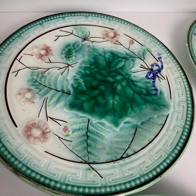 A beautiful set of six German majolica plates featuring raised botanical motifs in blue‑green with a subtle pink flower...