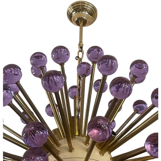 Striking Italian modern Sputnik chandelier, featuring radiant brass arms tipped with hand-blown purple Murano glass orbs....