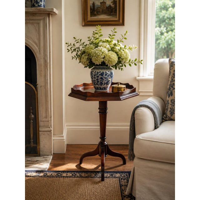 A beautifully proportioned mid-20th century mahogany side table with an octagonal parquetry top, shaped gallery edge, and...