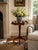A beautifully proportioned mid-20th century mahogany side table with an octagonal parquetry top, shaped gallery edge, and...
