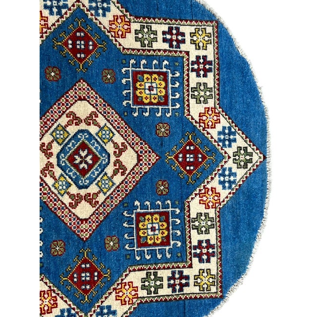 Afghan tribal geometric round rug, hand-knotted in Afghanistan from 100% wool. Measuring 3’3” x 3’3”, the rug features a...