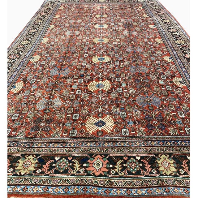 ACTUAL SIZE: 11’9″ x 19’6″ PRIMARY COLOR: Rust / Navy AGE: Antique ORIGIN: Iran MATERIALS: Wool FOUNDATION: Cotton...