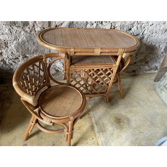 Set of table and two chairs that fit under the table. 70s rattan. Table dimensions :103/52 h75, chair dimensions :height...