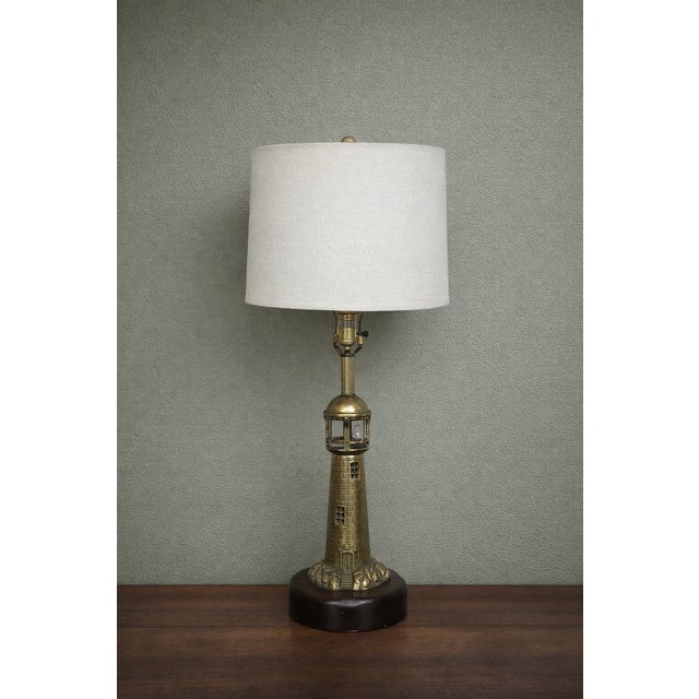 This vintage Nauticus lighthouse table lamp is a striking coastal-inspired accent piece, ideal for nautical, maritime, or...