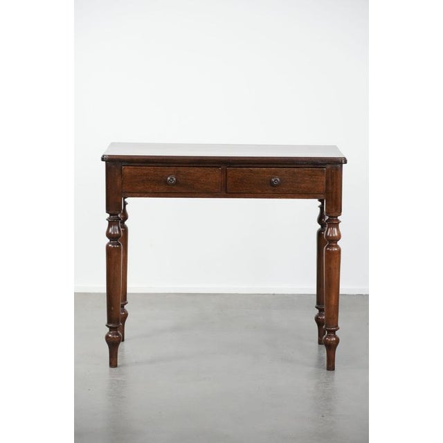 We are offering this beautiful, understated antique English hallway cabinet/side table from the late 19th century. This...