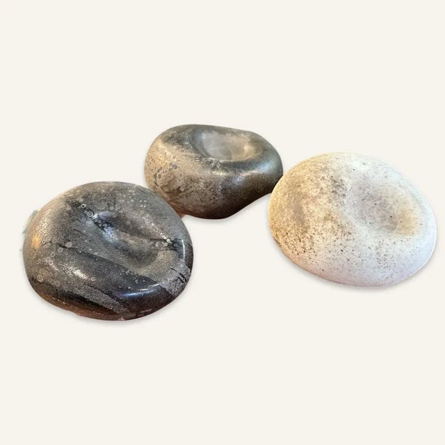 This set of 3 molded glass stones with clear glass “eyes” were designed by Murano glassmaker Alfredo Barbini in 1962. They...