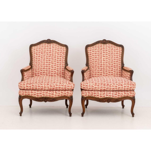 Pair of Louis XV Style Red and White Fabric Upholstered Walnut Bergeres, each with carved floral motif cresting and...