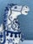 Vintage blue and white ceramic Tang style horse figurine featuring intricate floral patterns and caparisoned details. The...