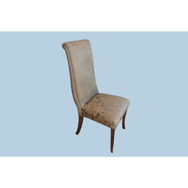 Green damask dining chair. Thin wooden legs that are painted silver. Okay condition, fabric on the back of the chair is...