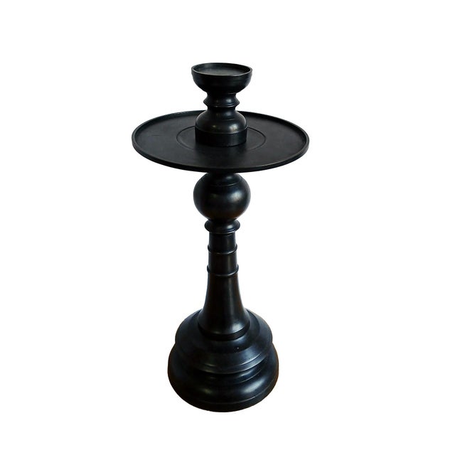 A medium-size candlestick in forged bronze with black satin finish. Indonesia, contemporary. The diameter top plate, at 8...
