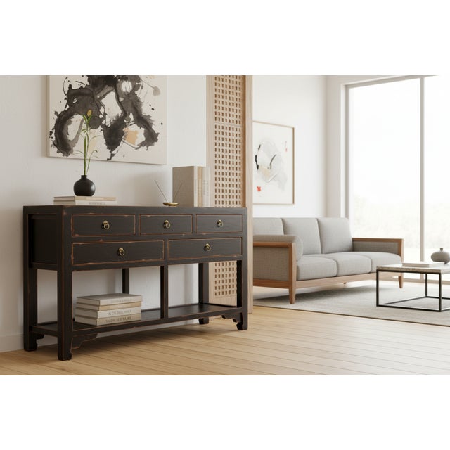 A refined example of Chinese furniture design that balances storage with open display space. This sideboard features a...