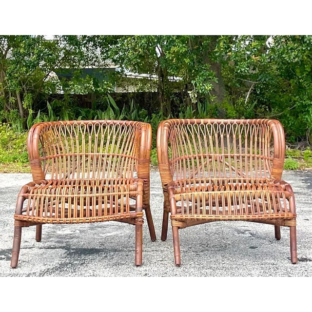 This elegant pair of vintage lounge chairs is a sculptural masterclass in organic Mid-Century Modern design. Expertly...