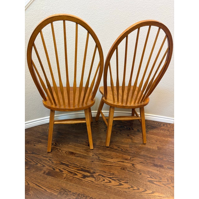 Bring timeless warmth and craftsmanship to your home with this handsome pair of vintage solid wood hoop-back Windsor...
