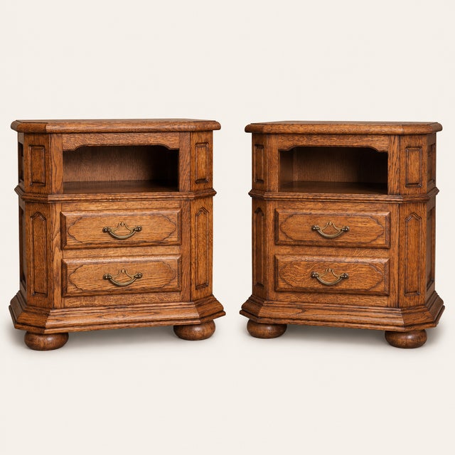 A substantial pair of 1960s oak nightstands crafted in the French Provincial tradition. Each features an open upper shelf,...
