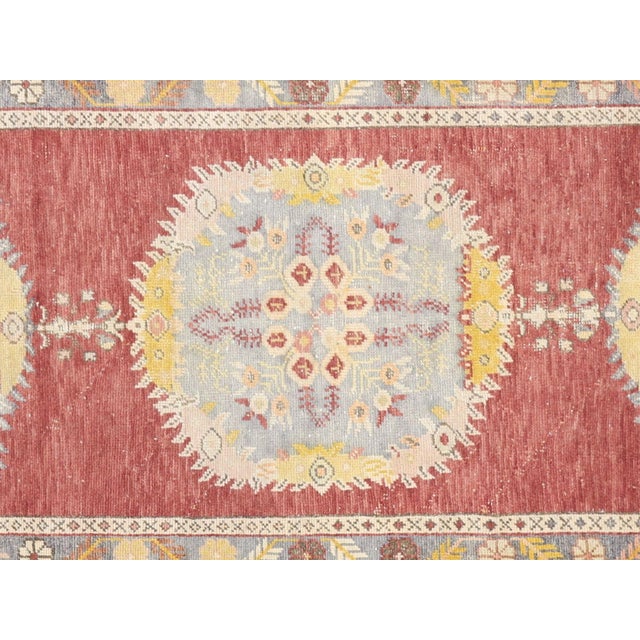 Handwoven vintage Turkish Oushak runner measuring 3'2" x 12'7". Crafted with wool on wool foundation in Western Turkey's...
