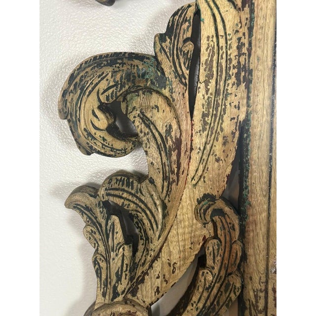 A striking and highly sculptural 20th century Italian carved wood mirror, richly ornamented with scrolling acanthus...