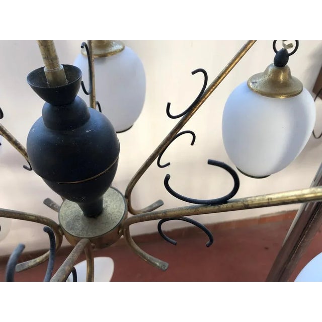 Black and brass aluminum structure. Consisting of 6 opal glass lampshade. Produced and designed in Italy with inspiration...