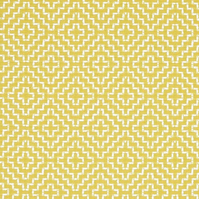 With its nuanced tonal variations and cross-stitch pattern, this graphic fabric has the appeal of a handcrafted textile....