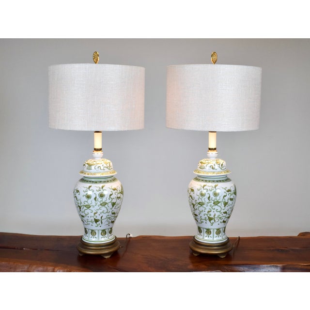 An extraordinary pair of Chinese Ginger Jar lamps with intricate Artichoke and Sunflowers floral motif; hand painted in...