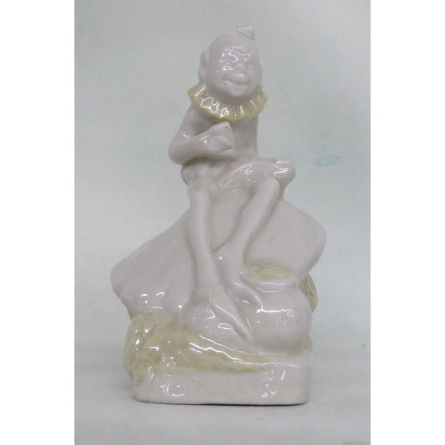This wonderful figurine is made of porcelain. This figurine is stamped on the bottom as being made by Belleek in Ireland...