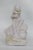 This wonderful figurine is made of porcelain. This figurine is stamped on the bottom as being made by Belleek in Ireland...