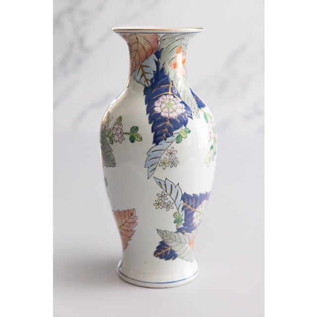 A lovely vintage Chinese tobacco leaf pattern porcelain vase with pink peony flowers surrounded by colorful foliage and...