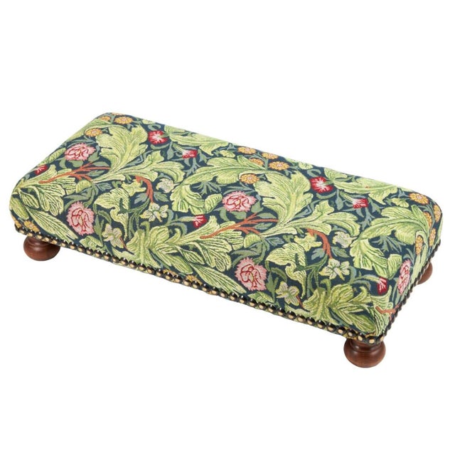 Meticulously handcrafted in the United Kingdom, this upholstered stool boasts classic studding and hand-polished solid...