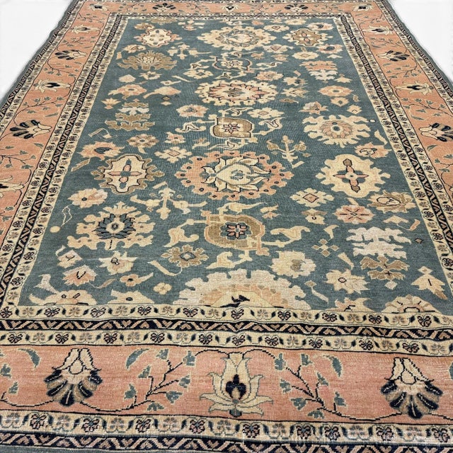 This vintage Sultanabad-inspired rug captures the timeless elegance and decorative richness of classical Persian design,...